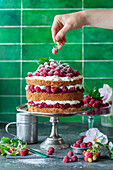 Naked cake with vanilla cream and fresh raspberries