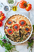Garden focaccia with tomatoes, herbs and flowers
