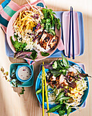 Vietnamese noodle salad bowls with grilled chicken and herbs