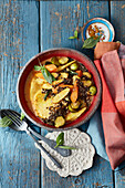 Beluga lentil curry with oven-roasted vegetables and pineapple