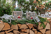 candle lanterns on woodpile