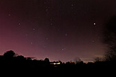 Jupiter and faint aurora in night sky, December 2023