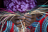 Woman weaving basket, Kenya