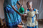 Mother washing her daughter's hands, Kenya