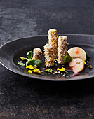 Goat's cheese rolls in amaranth breading with marinated vineyard peaches