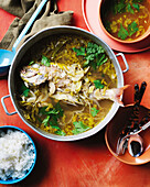 Asian fish stew with herbs and rice garnish