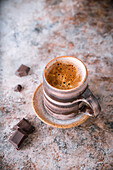 A mug of coffee and dark chocolate