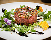 Steak tartare with rocket and edible flowers