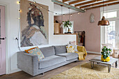 Living room with grey sofa, wooden beamed ceiling and fairy lights