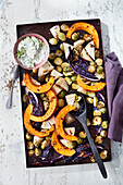 Winter oven vegetables with cashews and cucumber raita