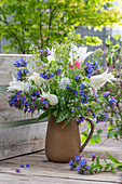 Bouquet of lungwort (Pulmonaria officinalis), shepherd's purse, wild garlic flowers, tulip 'White Triumphator' (Tulipa) in a jug