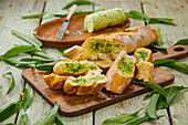 Baguette with wild garlic butter and fresh wild garlic leaves