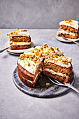 Carrot cake with cream cheese frosting and nut topping