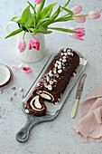 Chocolate sponge roll with cream cheese filling and Easter decoration