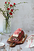 Chocolate sponge roll with cherry and creamcheese