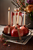 Stick candles in pomegranates - decoration for a Turkish evening