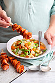 Noodle soup with vegetables and toast and sausage skewer