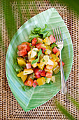 Fresh fruit salad on a green, leaf-shaped plate