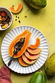 Papaya half and pieces on a plate