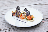 Salmon tataki with artichoke, lemon confit and black hips