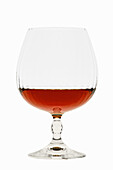 Glass of brandy against a white background