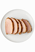 Top view of plate with sliced baked pork fillet