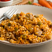 Rice paella with vegetables and Iberian pork loin