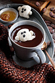 Hot drinking chocolate with a ghost shaped jelly for Halloween