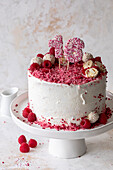 Raspberry and coconut cake with Raffaello and number cake topper