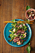 Asian salad with deep-fried duck breast and lychees