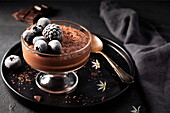Chocolate mousse with chocolate shavings and dark berries