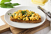 Toasted sourdough topped with scrambled egg and wilted wild garlic.