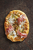 Potato galette with prosciutto, parmesan and pine nuts
