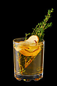 Hot apple winter drink with thyme and ginger isolated on black