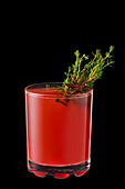 Hot cranberry winter drink with thyme, cloves and anise isolated on black