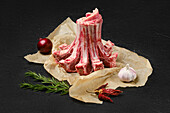 Raw lamb crown roast with rosemary and garlic