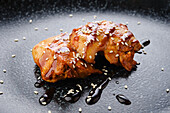Grilled chicken with teriyaki sauce and sesame seeds