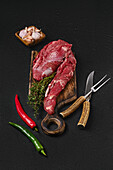 Raw fillet of beef with garlic, chilli and thyme