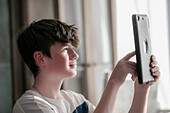 Teenage boy using digital tablet