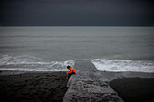 Lonely boy sitting on slipway