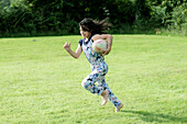 Young girl playing rugby