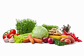 Various vegetables and herbs against a white background