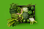 Various green vegetables in a wooden box