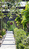 Covered garden path with green planting