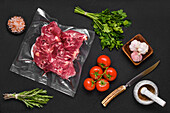Vacuum-packed lamb neck with tomatoes, garlic and herbs