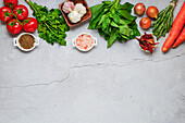 Vegetables and herbs on a concrete base