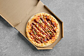 Barbecue pizza with bacon and spring onions