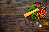 Ingredients for spaghetti with spinach and tomatoes