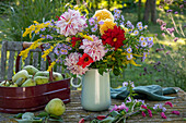 Autumn bouquet of dahlia (Dahlia), goldenrod (Solidago), aster, physostegia (Physostegia virginiana) and pears in a harvest basket