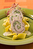 Veal rolls with watercress filling on ribbon noodles